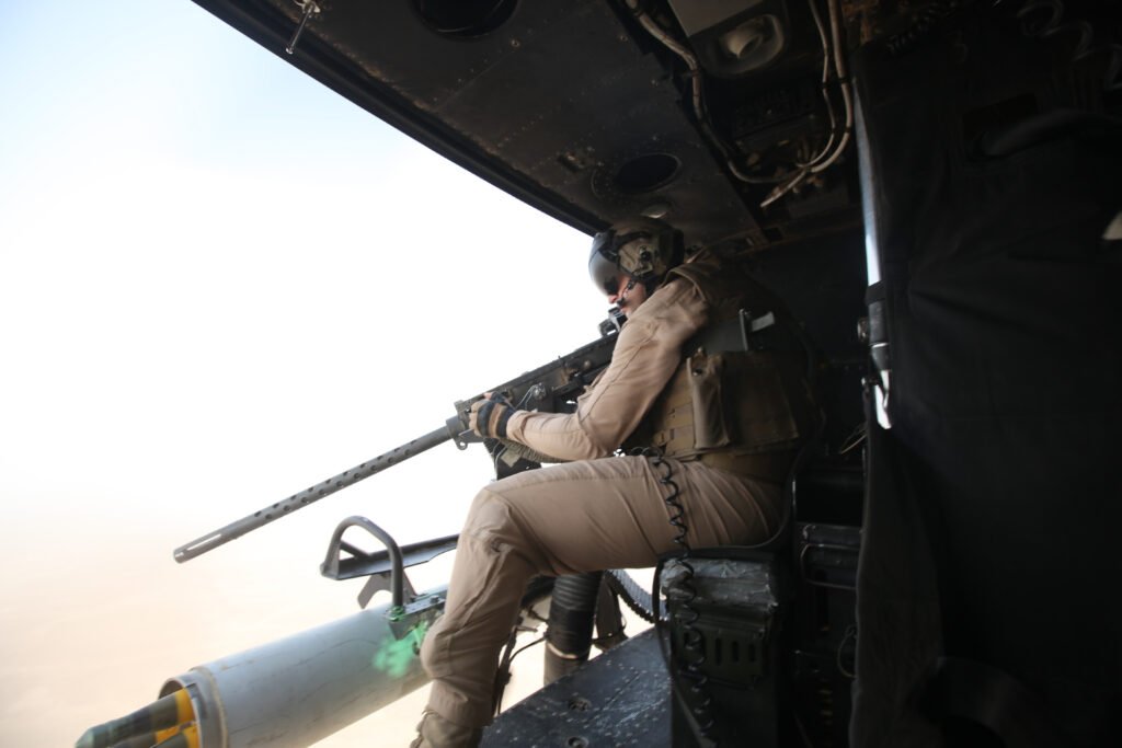 U.S. Marine crew chief manning a door gun aboard a helicopter during a combat deployment in Helmand province, Afghanistan