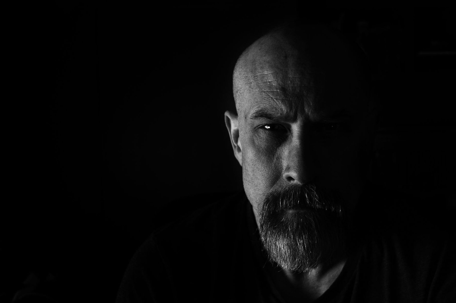 A portrait of a man with a steady, serious expression.